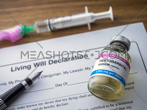 Living will declaration form Next to a vial of pentobarbital sodium to proceed to euthanasia, conceptual image