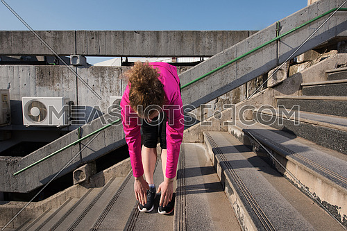 runner   woman warming up and stretching before morning jogging