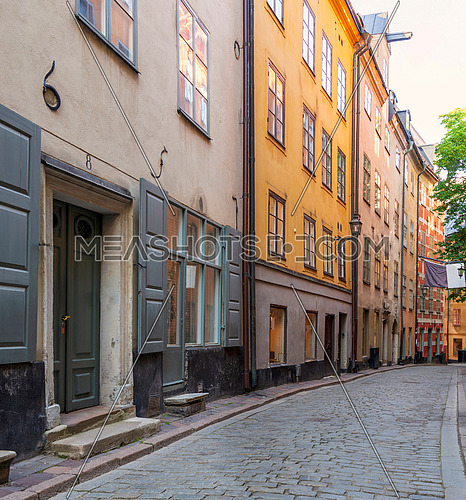 Narrow alley located in Gamla stan, the old town of Stockholm, Sweden with old style colorful houses and cobblestone street