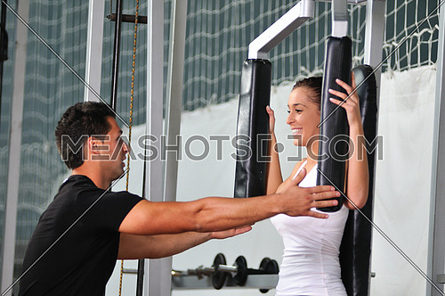 woman in the fitness gim working out with personal trainer coach
