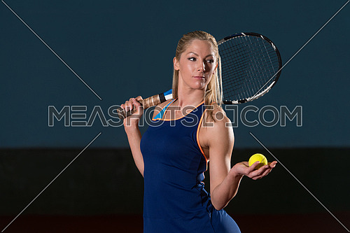 Portrait Of Female Tennis Player With Racket Ready To Hit A Tennis Ball