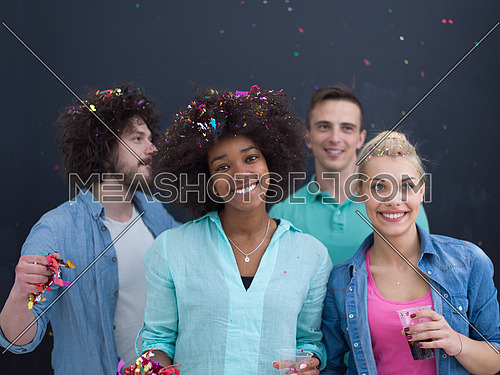 confetti party Multiethnics group of happy young people celebrating new year eve while dancing and have fun at home isolated over gray background