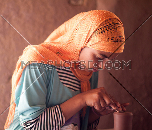 Young girl at pottery school in Tunis Village, Fayoum, Egypt