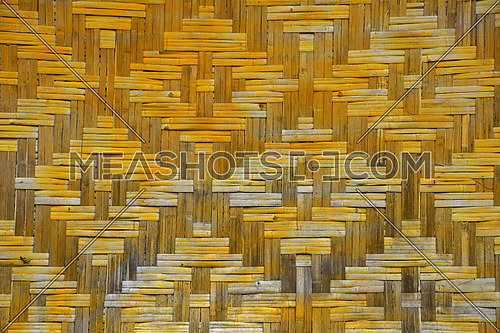 Wicker braided bamboo yellow and brown painted wall texture pattern