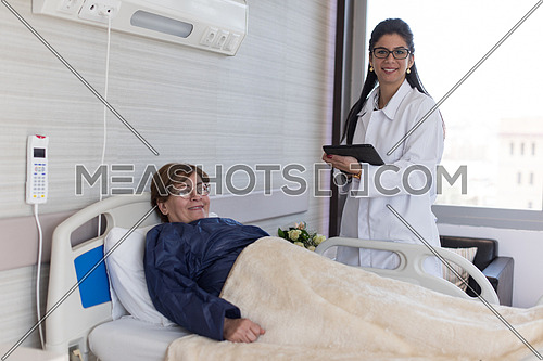 young middle eastern doctor and patient in the hospital room to a large modern clinic