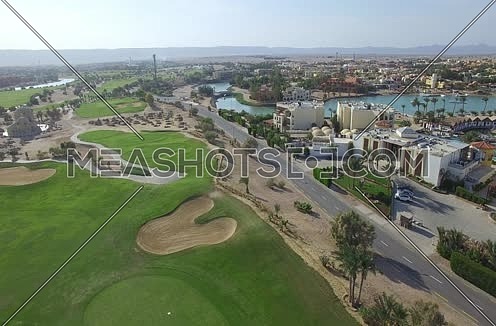 Drone shot flying above a golf course Al Gouna at Day 