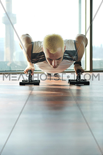 young healthy man exercise fitness indoor in sport studio