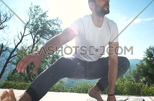 man doing exercise in front of villa