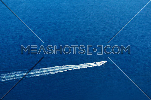 fast motor speed boat travel with splash and wake on blue tropical sea backround