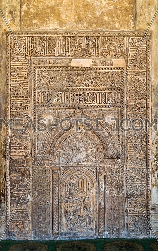 Ornate engraved stone wall with floral patterns and calligraphy at Tulunid era Ibn Tulun Mosque, Cairo, Egypt