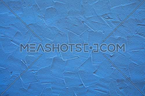 Rough blue wall surface of decorative embossed painted lime plaster background texture, close up