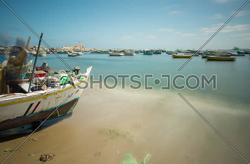 Fixed shot for small boats moored to the shore in alexandria at day