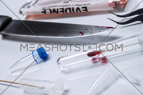Detail of swab with traces of blood with a knife in the laboratory scientist