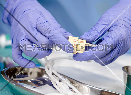 Doctor holds a flow dial on a hospital table, conceptual image