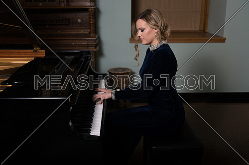 Piano Playing Pianist Concert - Classical Music Musician Player With Grand Piano in Darkness