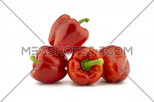 A stack of red bell peppers isolated on white background
