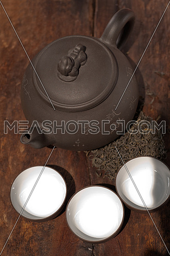 chinese green tea traditional  pot and cups over old wood board