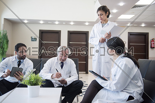 middle eastern doctors and medical staff at a meeting in a modern hospital