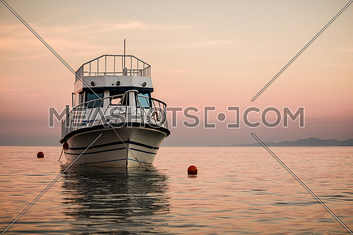 A Big fishing boat anchored to the sea