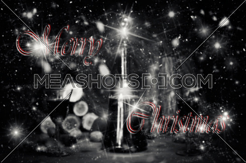 Merry Christmas Sign With Red Wine Vintage Bottle and Glasses Resting On Wooden Table With Stardust and Snowflakes in The Background