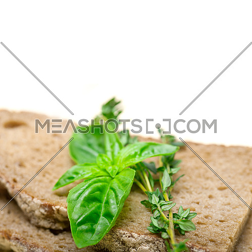 rustic Italian bread basil and thyme simple snack on white wood table