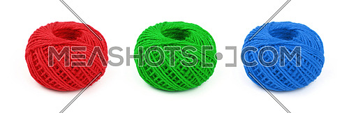 Three colorful multicolor small round coil bobbins of natural red, green and blue twine hessian burlap jute rope isolated on white background, close up, high angle view