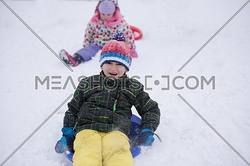 group of children having fun and play together in fresh snow on winter vacation