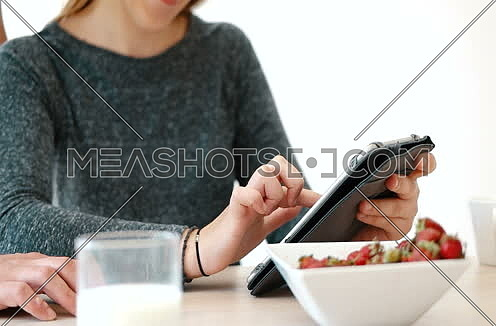 couple enjoying time together while eatinga and using technology