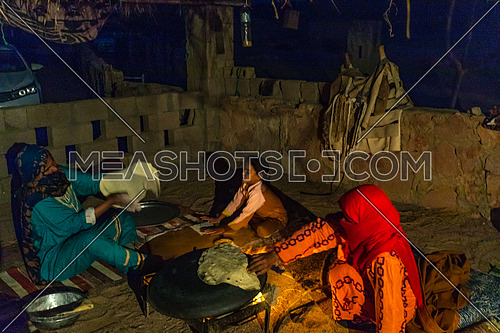 Bedouin Females cooking traditional food at a shelter in Sainai at Night