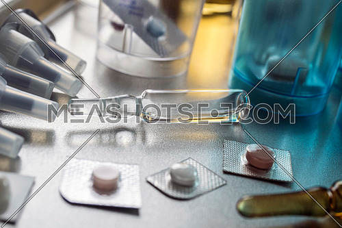 Diverse medication in glasses monodose along with Blister glass in hospital, conceptual image, horizontal composition