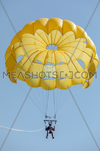 Tourist parasailng in the Red Sea by day