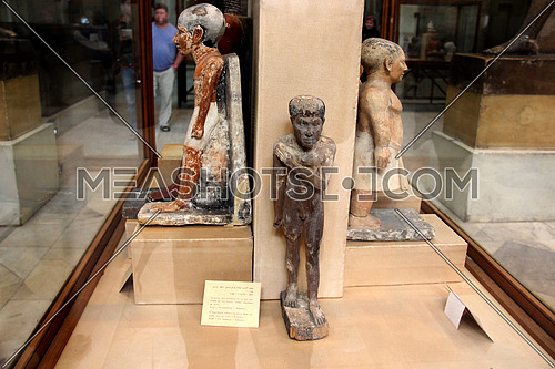 a photo from inside the Egyptian museum showing a display of monumental statues belonging to ancient pharaohs civilization
