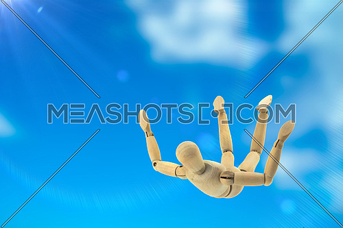 Doll wood flying in the sky in free fall, conceptual image