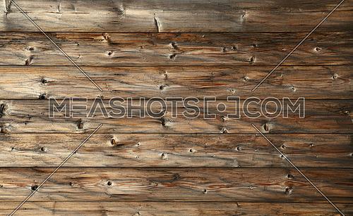 Dark and light brown old vintage knotty wooden wide planks wall background texture with aged gray and black grunge woodgrain pattern and gradient color