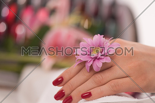 Beautiful fingers with french manicure on the towel. Manicure in a beauty salon.