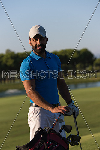 handsome middle eastern golfer portrait at golf course at sunny day