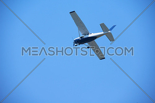 small retro airplane, clear blue sky in background