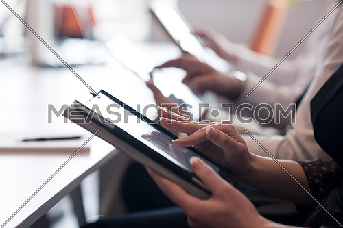 group of business people on meeting  using tablet computer in modern bright startup office interior