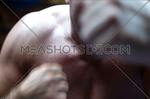 Portrait Of  Fighter or Boxer Throwing Punches Towards Camera