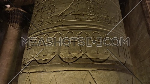 Orbit shot around Column with hieroglyphics writings inside Temple of Edfu Egypt
