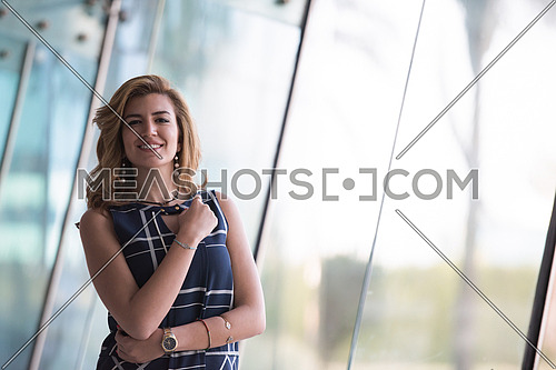 attractive middle eastern business woman portrait with travel bag at airport terminal