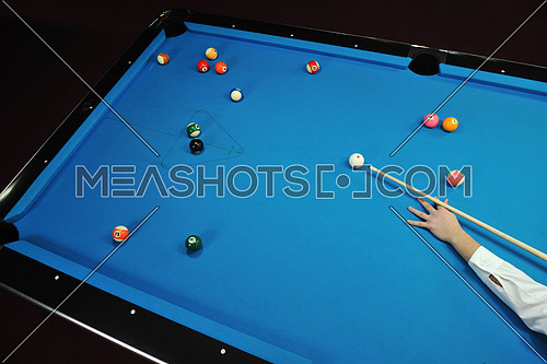 young pro billiard player finding best solution and right angle at billard or snooker pool sport  game 