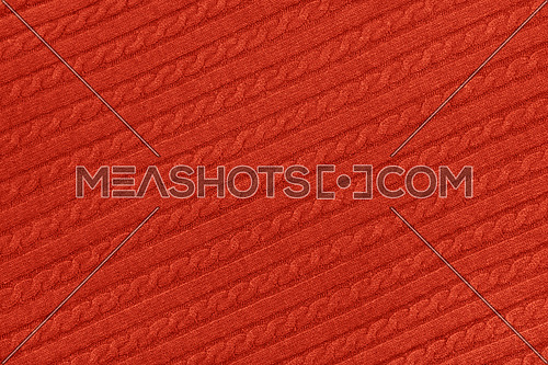 Close up background texture of red cable knitted wool jersey fabric sweater with row braid pattern