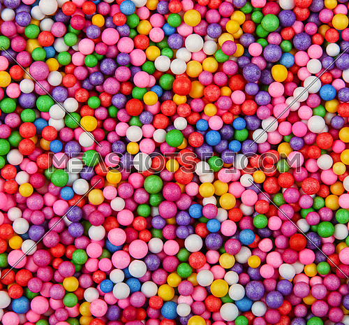 Abstract background texture of multicolor expanded polystyrene balls, close up