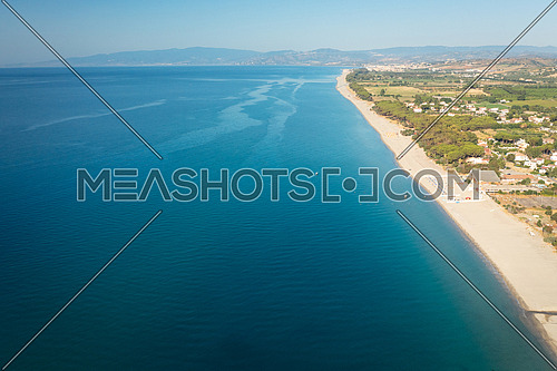 Aerial view of beautiful sea and beach at sunny day, seascape and hill mountain on backgrond, Simeri Mare, Calabria, Southern Italy