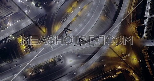 Aerial top left of spirally 6 of October Bridge over Abd Elmonan Reyad Bus Station At Tahrir Area in cairo at night