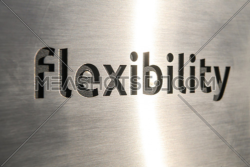 Engraving a CNC machine on a piece of metal. Engraving flexibility text. High quality photo
