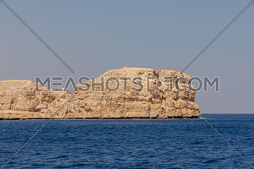 Long shot from Red Sea showing Ras Muhammed Island by day