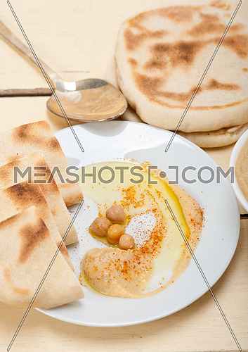 traditional chickpeas Hummus with pita bread and paprika on top 