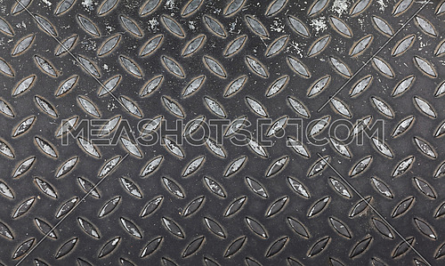 Dark gray industrial anti slip embossed metal steel plate with diagonal bumps of diamond pattern texture and black paint, background, close up